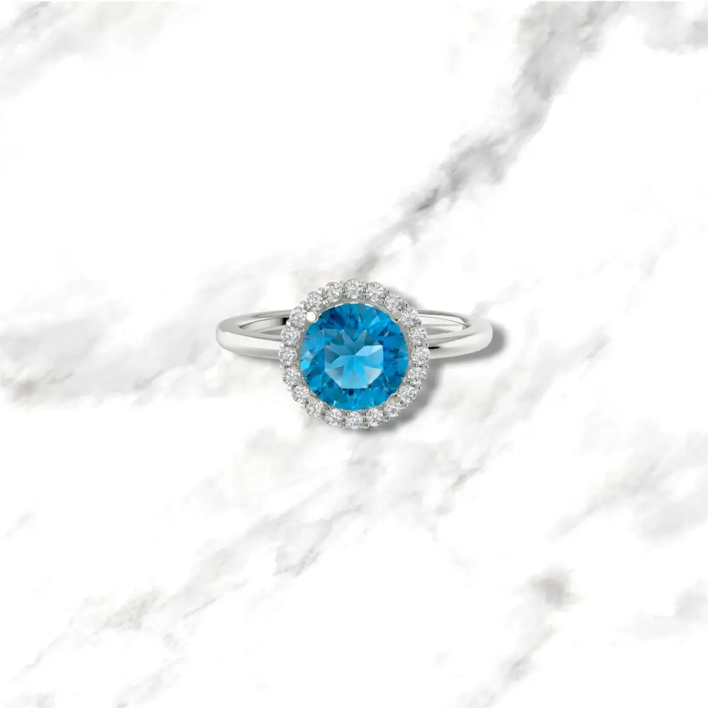 Anello in oro bianco 9kt con topazio azzurro e giro di diamanti